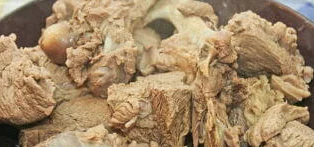 Отварное мясо делим на волокна и кладем на плоскую тарелку. Дополняем его луком и лапшой. Посыпаем ароматными специями.