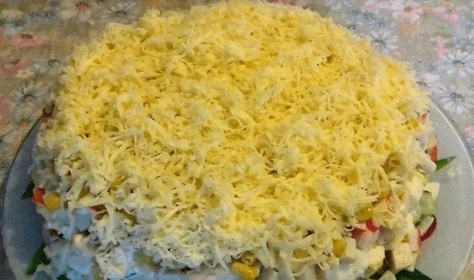 Слоеный салат с крабовым мясом, кукурузой, сыром и яйцами